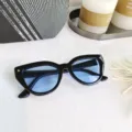 Black cat-eye sunglasses featuring stylish blue lenses, ideal for trendy street fashion looks. - Black Frame Blue Lens