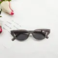 Retro cat-eye sunglasses with translucent grey frames and dark lenses. Chic vintage eyewear for women. - Jelly Gray Frame Gray Lens