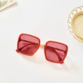 Detailed view of fashionable square sunglasses with red frame and pink UV400 lenses. - Red