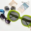 Detailed shot of trendy oversized round frame sunglasses in multiple vibrant colors for women. - Jelly Green