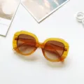 Detailed view of large round sunglasses with gradient brown lenses and amber acetate frame. - Transparent Yellow