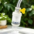 Water faucet anti-splash filter nozzle detail showing the adjustable valve and mesh water flow. - Short PP Cotton Filter Model / White