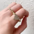 Gold plated copper beaded ring featuring a sparkling micro-paved zircon heart charm for women. - Heart