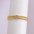 Pulsera de cuentas de doble capa chapada en oro con abalorio de letra D de circón. - Letra D