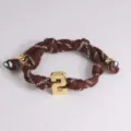 Brown braided rope bracelet featuring a 3D gold-colored number 2 charm and metal bead accents. - 2