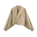 Close-up detail of the chic asymmetric wide lapel and stylish belted waist design. - S / Khaki