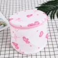 Detailed view of the cylindrical mesh laundry bag with pink heart patterns and durable zipper. - 15*16cm / Pink