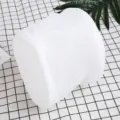 Detailed shot of a white cylinder mesh laundry bag with zipper on a grid background. - 15*16cm / White
