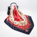 Detailed view of luxury chain print square silk scarf draped elegantly on a black handbag. - Navy Blue