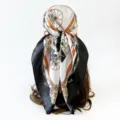Detailed view of women carriage chain print silk square scarf showing back styling design - Black