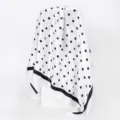 Detail view of the elegant white satin square scarf with classic black polka dots. - D9350-White