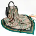 Detail view of a luxury paisley printed silk scarf, elegant green and brown square wrap. - D9253-Green
