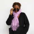 Lavender fringed winter scarf detail view, soft cashmere-feel fabric shown worn by model. - Purple