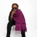 Close-up detail of the dark red imitation cashmere fringed scarf draped elegantly on model. - Dark Purple
