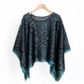 Detail view of ethnic pattern on satin poncho scarf hanging on a wooden hanger - TL11009 Black and Blue