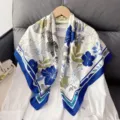 Exquisite floral print silk scarf detail, showcasing elegant blue and white pattern design. - Blue