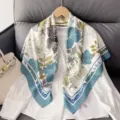Detail view of the 90cm twill silk square scarf featuring elegant floral and zebra pattern design. - Cyan