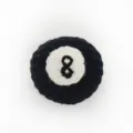 Close-up product detail showing the texture of the handmade crochet billiard 8-ball pendant. - Billiards