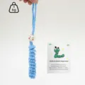 Handmade crochet worry worm detail view, cute blue hanging ornament with wooden bead face. - Light Blue
