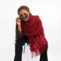 Solid red cashmere-feel scarf detail view, elegant tassel trim, warm winter accessory. - Wine Red