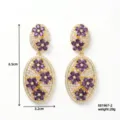 Elegante vergoldete Ohrringe mit lila Blumen und glitzernden Zirkonia Kristallen. - Paars (E01967-2)