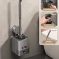 Wall-mounted silicone toilet brush with holder, drainage tray, and ergonomic handle. - Silicone Handle Suction Toilet Brush Set / Gunmetal