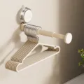Wall-mounted telescopic clothes hanger rack with suction cup for easy daily storage. - 1 Piece/Pack / Cream White