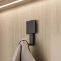Modern black wall-mounted coat hook for entryway. Durable metal single hook design. - 1PC / Black