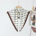 Detailed view of white silk-imitation square scarf with black polka dots and brown border. - White with Black Polka Dots