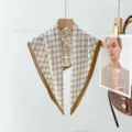Detailed view of the vintage monogram pattern square scarf with elegant brown border design. - XPM-2