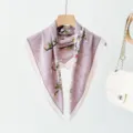 Detailed view of the elegant light purple floral square scarf hanging on a wooden hanger. - XPM-20