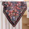 Silk scarf detail showing black paisley floral pattern with vibrant red and blue colors. - RY-21