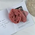 Detailed view of pink polka dot chiffon scarf, elegant rolled rose shape flat lay setup. - Dark Pink Small Polka Dots