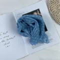 Detailed view of a blue polka dot chiffon scarf, lightweight, elegant and vintage. - Blue Polka Dot