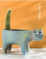 Detailed view of the ceramic cat shaped flower pot with vintage blue glaze and cactus tail. - Standing Cat (Without Plant)