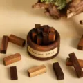Detail shot of black walnut wood aromatherapy diffuser blocks in a small bowl, flameless scent. - Black Walnut Diffuser Set