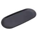 Close-up detail of the minimalist matte black oval tray, featuring smooth edges and surface. - Tray / Black