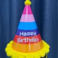 Colorful children's birthday party conical hat close-up, cute yellow pom-pom detail. - Yellow Cone Hat / Yellow
