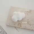 Detailed view of a minimalist white cloud scented candle showcasing its unique wax texture. - Freesia / White