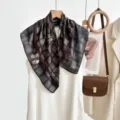 Close-up detail of luxury vintage plaid silk scarf, elegant draped pattern and soft texture. - CY-1