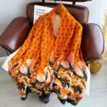 Detailed view of women's long silk scarf featuring traditional dragon and cloud patterns, elegant. - Auspicious Dragon Bringing Prosperity