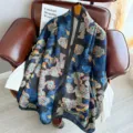 Detailed view of vintage black silk scarf featuring blue and gold traditional cloud patterns. - Auspicious Clouds, Flowers and Birds Pattern