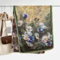 Detail shot of a vintage floral silk scarf with exquisite rolled hems and rich golden tones. - Style 15