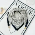 Dettaglio della sciarpa geometrica in bianco e nero con eleganti ciondoli dorati. - Stile di fibbia magnetica 3