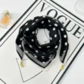 Black and white polka dot silk scarf with elegant gold corner charms, flat lay detail view. - Magnetic Buckle Style 7