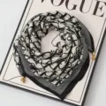 Chic black and white monogram square scarf with metal charm accents for stylish women neck wear. - Magnetic Buckle Style 15