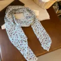 Detailed view of the light blue polka dot chiffon scarf with elegant french style. - Light Blue Polka Dot Style