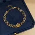 Detail view of the vintage gold-tone mesh lace bracelet with square filigree pendant. - Gold-Square