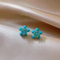 Close-up detail shot of exquisite blue floral stud earrings with gold stamen accents, elegant. - 6# Silver Post - Gold - Blue (Real Gold Plated)