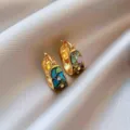 Detailed shot of vintage gold huggie earrings inlaid with colorful shell and zircon stones. - 4# Real Gold-Plated Huggie Earrings - Gold & Blue